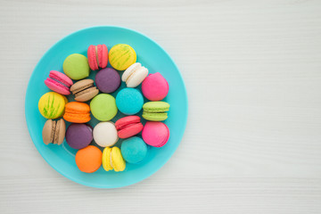 Colorful france macarons on white table background