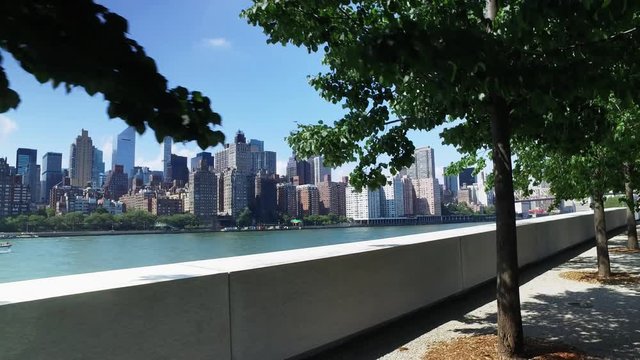 The midtown Manhattan skyline as seen from the treelined paths at Franklin D. Roosevelt Four Freedoms Park on the south end of Roosevelt Island.	 	