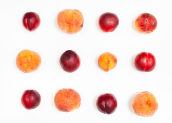 set from ripe nectarines and peaches on white
