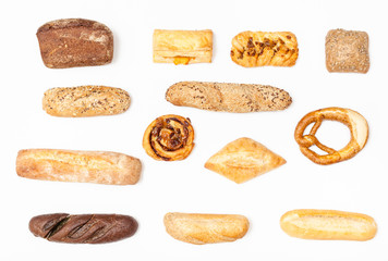 various fresh buns and loaves on white background