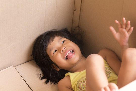 asian children smiling in a carton box