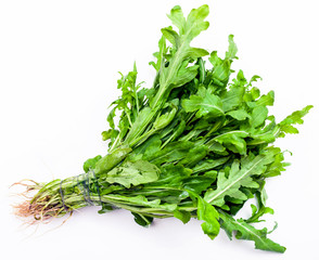 bunch of fresh cut green arugula herb on white