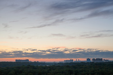 blue sky with pink horizon over city