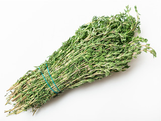 bunch of fresh cut green thyme herb on white
