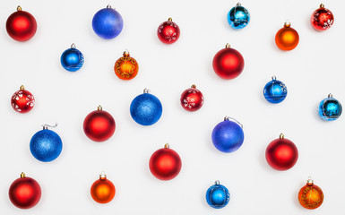 many blue, red, orange christmas balls on white