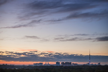 Fototapeta na wymiar dark blue sky with pink horizon over city at dawn