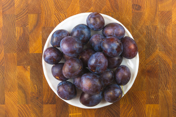 small plums on a white saucer