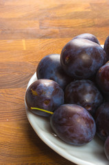 small plums on a white saucer