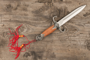 Dagger lying on a wooden surface