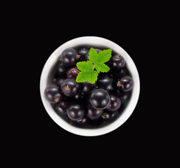 Ripe and tasty black currant isolated on black background. 