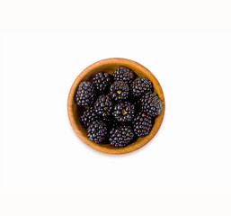 Blackberry on white background. Blackberries on a wooden bowl.