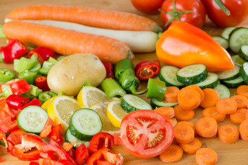 beautiful cut vegetables on a wooden board in the kitchen