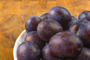 small plums on a white saucer