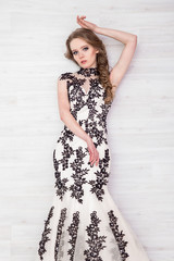 Portrait of a beautiful girl in a beautiful dress with patterns by Parliament