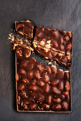 ..Chocolate bar over black background top view.