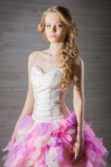 Portrait of a beautiful girl in a pink dress skirt