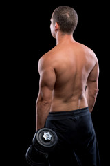 Fototapeta na wymiar bodybuilder lifts heavy dumbbell on a black background