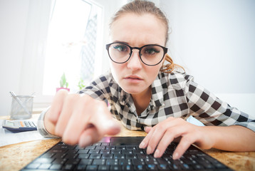 Woman browsing internet with laptop in home office, webcam view