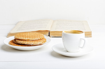 Cup of espresso, waffles and book
