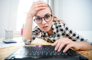 Surprised woman browsing internet in home office, webcam view