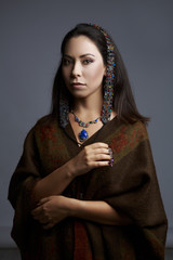 Portrait of a beautiful woman in traditional dress drilled
