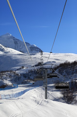 Chair-lift at ski resort in sun winter morning