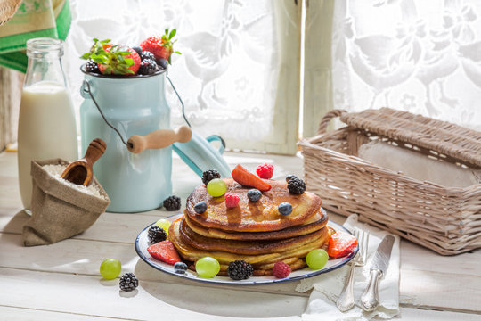 American pancakes with fruits and maple syrup