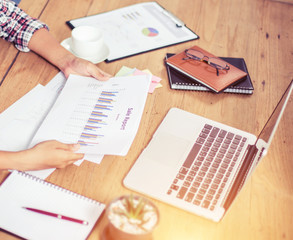 Business Woman Writing with pen in notepad on workplace.