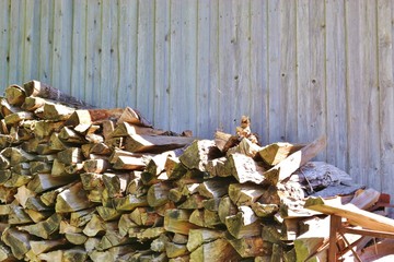 A woodpile in front of a wooden barn. Bavaria, Germany.