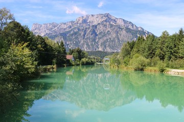 Beautiful landscape with the Salzach river  a goal for canoe polo is placed in the middle of the river. In the background the mountain Untersberg. Puch, near the city Salzburg, Austria. © utamaria