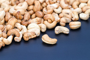 Roasted cashew nuts on black plate