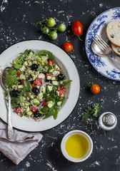Quinoa and vegetables salad on a dark background. Delicious vegetarian food