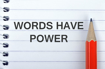 Words have power text on notepad and pencil