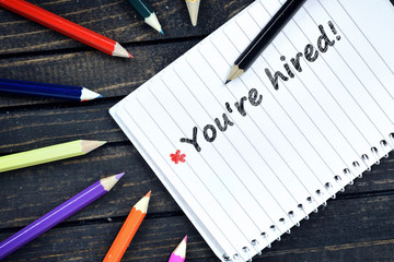 You're Hired text on notepad