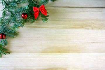Christmas background: oak table and a sprig of fir with toys, copy space