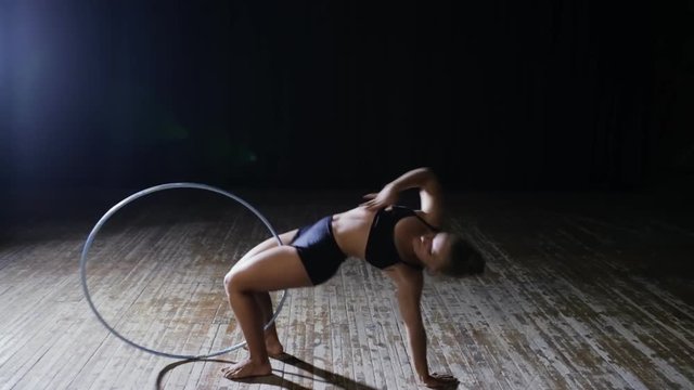 Art gymnastics. Woman move with hula hoop.
