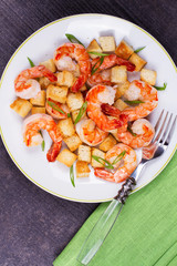 Shrimp with crispy croutons and scallions. View from above, top studio shot