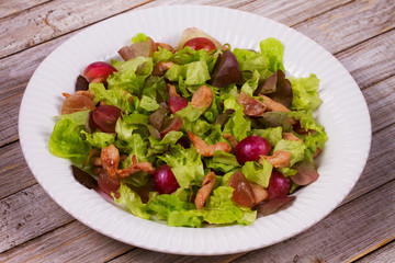 Chicken and red grape salad in white plate.