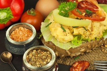 Fresh scrambled eggs on sunflower bread. Healthy food . Domestic food preparation. Eggs for a snack. Diet food. Toasted bread with scrambled eggs.
