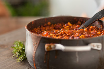 Organic Vegetarian Chili In Iron Pot Served With Rosemary On Dis - obrazy, fototapety, plakaty