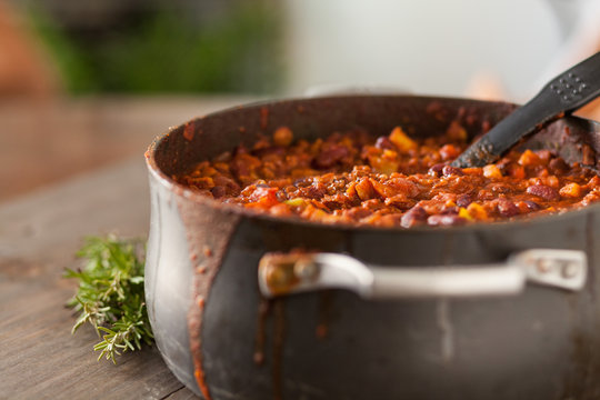 Organic Vegetarian Chili In Iron Pot Served With Rosemary On Dis