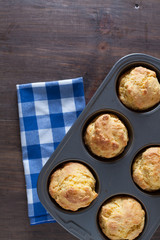 Corn Bread Muffins In Muffin Pan On Country Distressed Wood Tabl