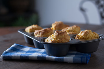 Corn Bread Muffins In Muffin Pan On Country Distressed Wood Tabl