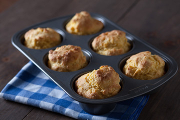 Corn Bread Muffins In Muffin Pan On Country Distressed Wood Tabl