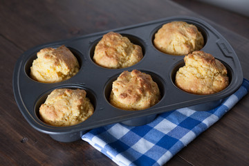 Corn Bread Muffins In Muffin Pan On Country Distressed Wood Tabl