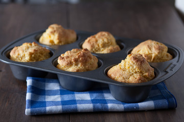 Corn Bread Muffins In Muffin Pan On Country Distressed Wood Tabl