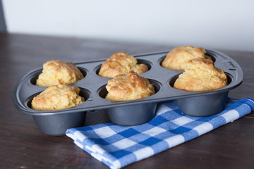 Corn Bread Muffins In Muffin Pan On Country Distressed Wood Tabl