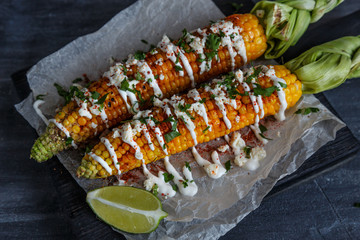 Elote or Mexican grilled corn on the cob served with cotija cheese and chili powder.