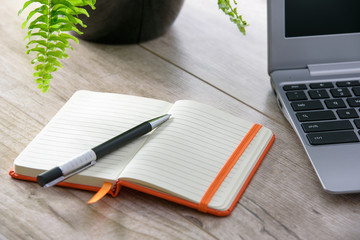 Personal notes in orange notepad - Powered by Adobe