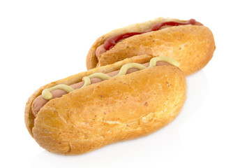 Hot dog with mustard and ketchup on white
